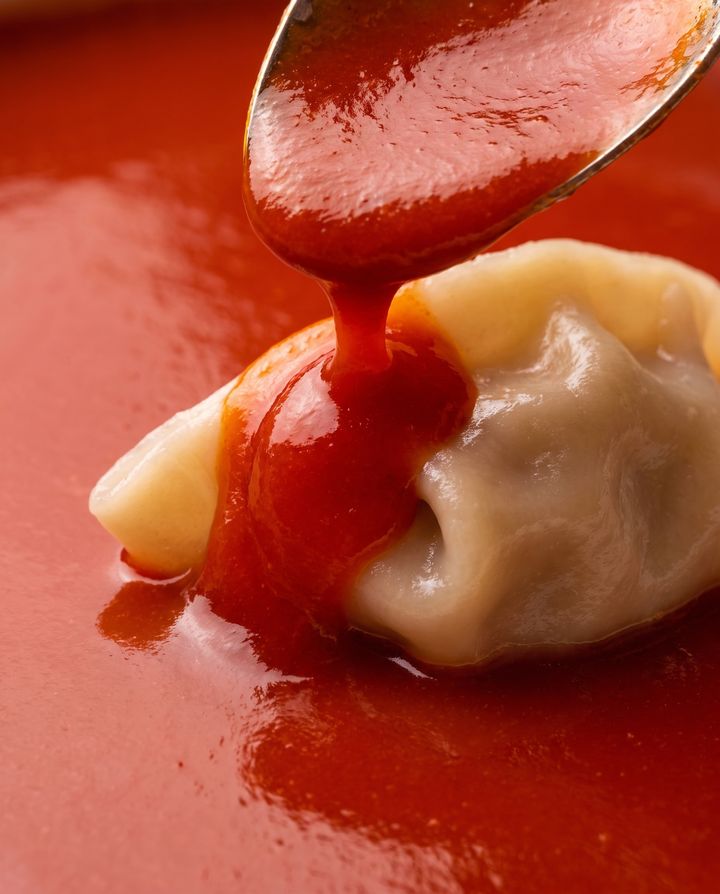 Red sauce poured over dumplings